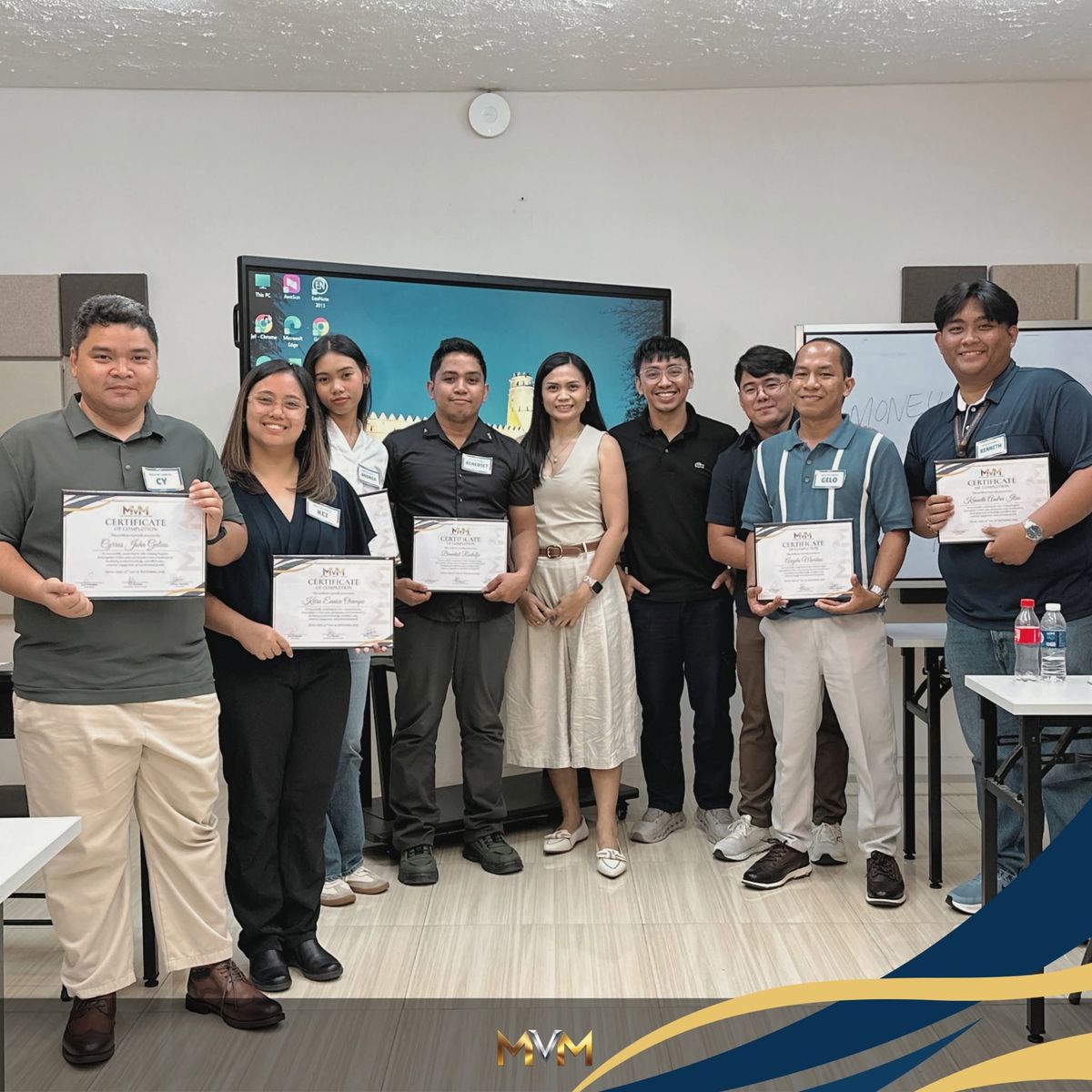 Participants receiving certificates of completion at an MVM Marketing training